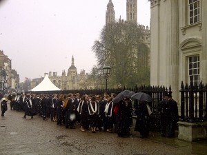 snow falls on the graduates
